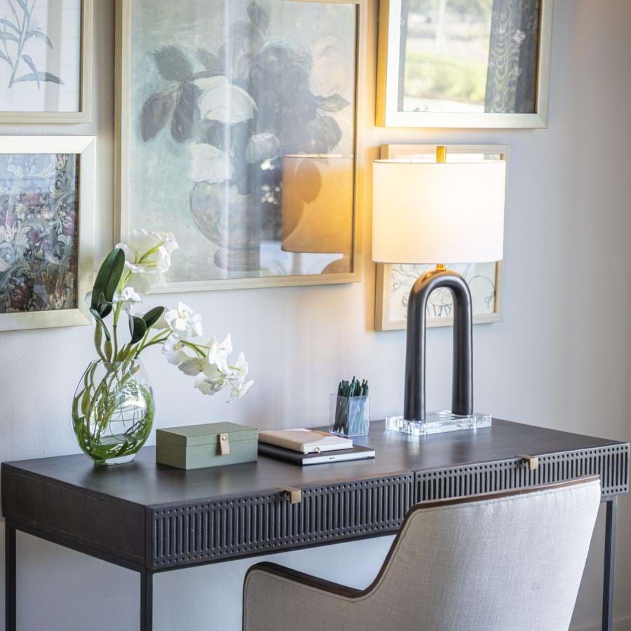 desk with a lamp and flowers