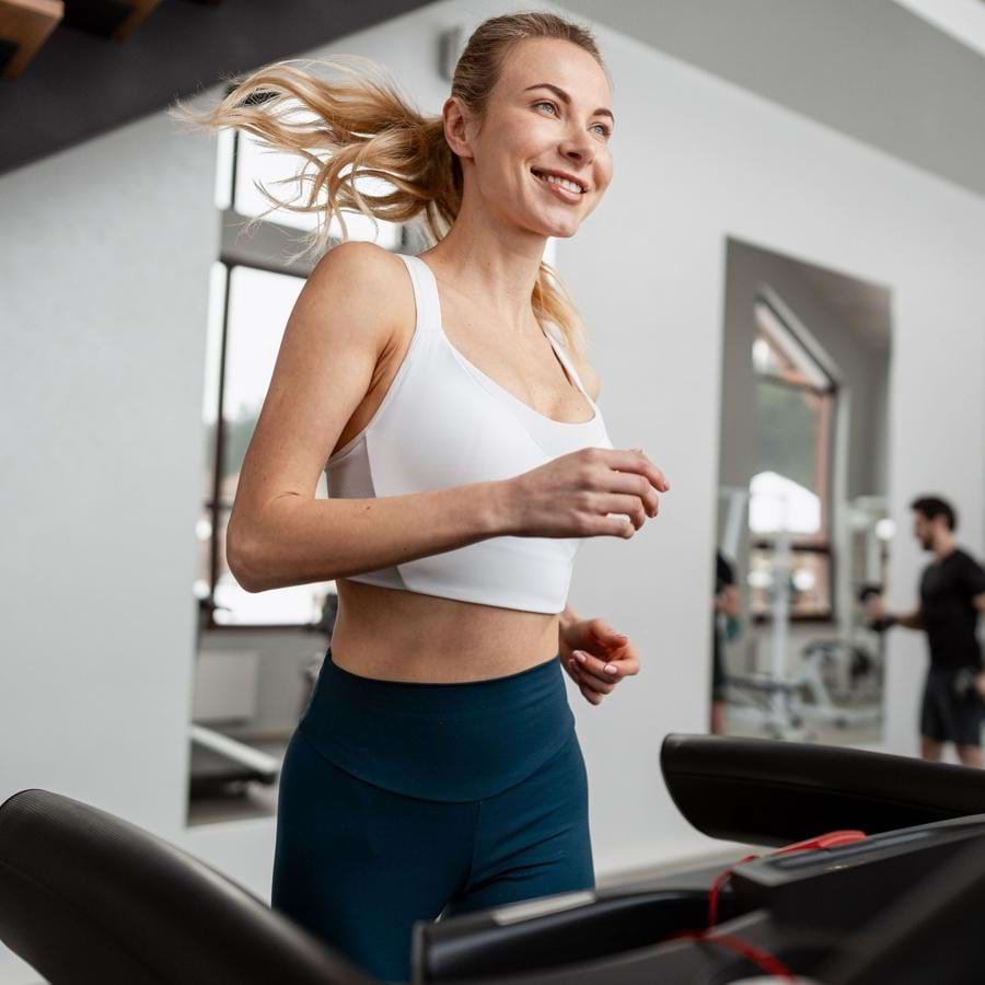a woman running on a treadmill